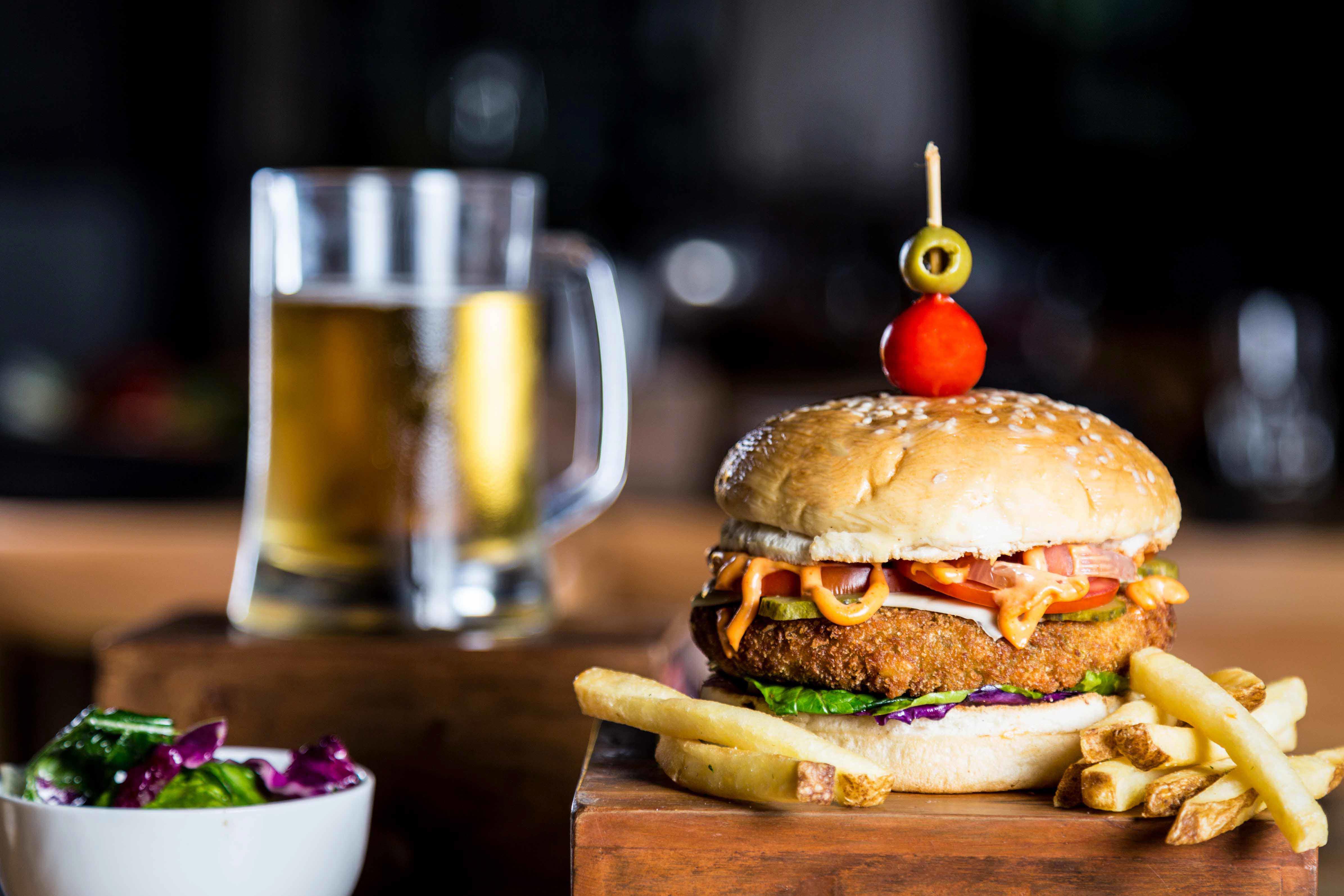image of a classic burger with a chilled beer in a goa restaurant